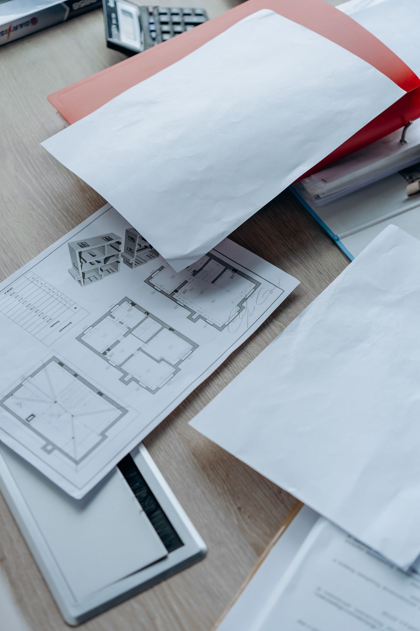 Property plans and paperwork on a desk